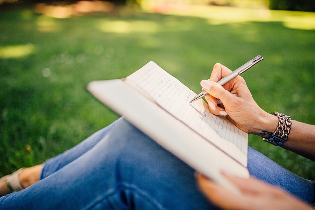 bookseller writing blog notes at wood desk with books